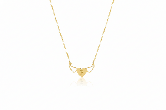 Gold necklace with a heart-shaped pendant on a white background