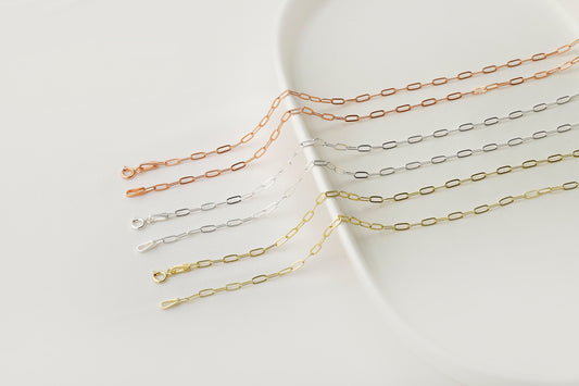 A close-up image of 6 link loop chain necklaces with a delicate and dainty design.