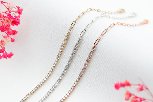A close-up image of a 3 half tennis half link chain bracelets with dainty CZ white diamonds in gold silver and rose color.