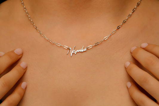 Necklace with 'Natalie' nameplate on a person's neck