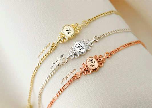 A collection of custom vintage style bracelets in gold, silver, and rose gold colors, each featuring an engraved letter.