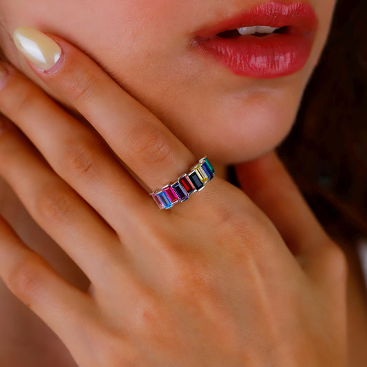 Close-up of a colorful ring on a finger with a blurred background