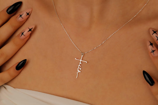 Silver necklace with a cross pendant on a person's neck