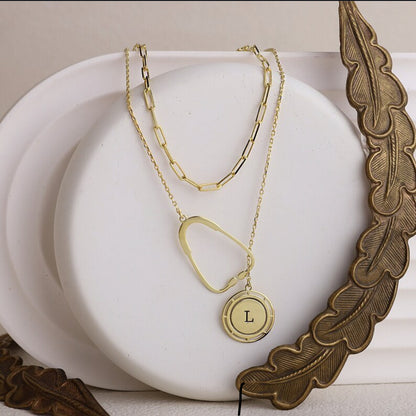 on https://silvergoldandrose.com/ . Gold necklace with a pendant on a white surface with decorative elements. Pulse Heart Stethoscope Necklace - Elegant Design Celebrating Healthcare Heroes