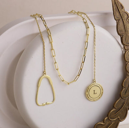 on https://silvergoldandrose.com/ . Gold necklaces on a white surface with a decorative frame. Pulse Heart Stethoscope Necklace - Elegant Design Celebrating Healthcare Heroes
