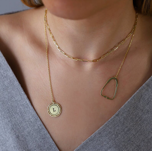 on https://silvergoldandrose.com/ . Gold necklaces with a pendant and chain on a person wearing a gray top. Pulse Heart Stethoscope Necklace - Elegant Design Celebrating Healthcare Heroes