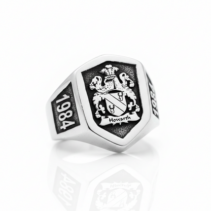Silver ring with emblem and '1984' on a white background