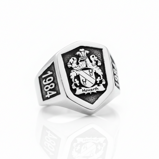 Silver ring with emblem and '1984' on a white background