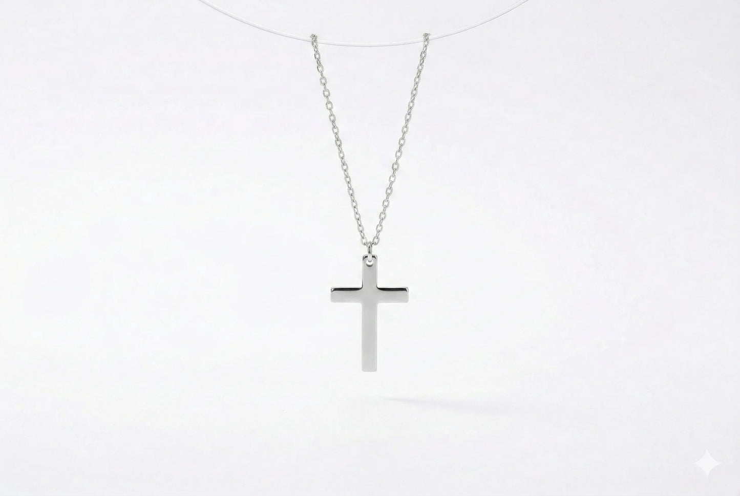 Silver cross necklace on a white background