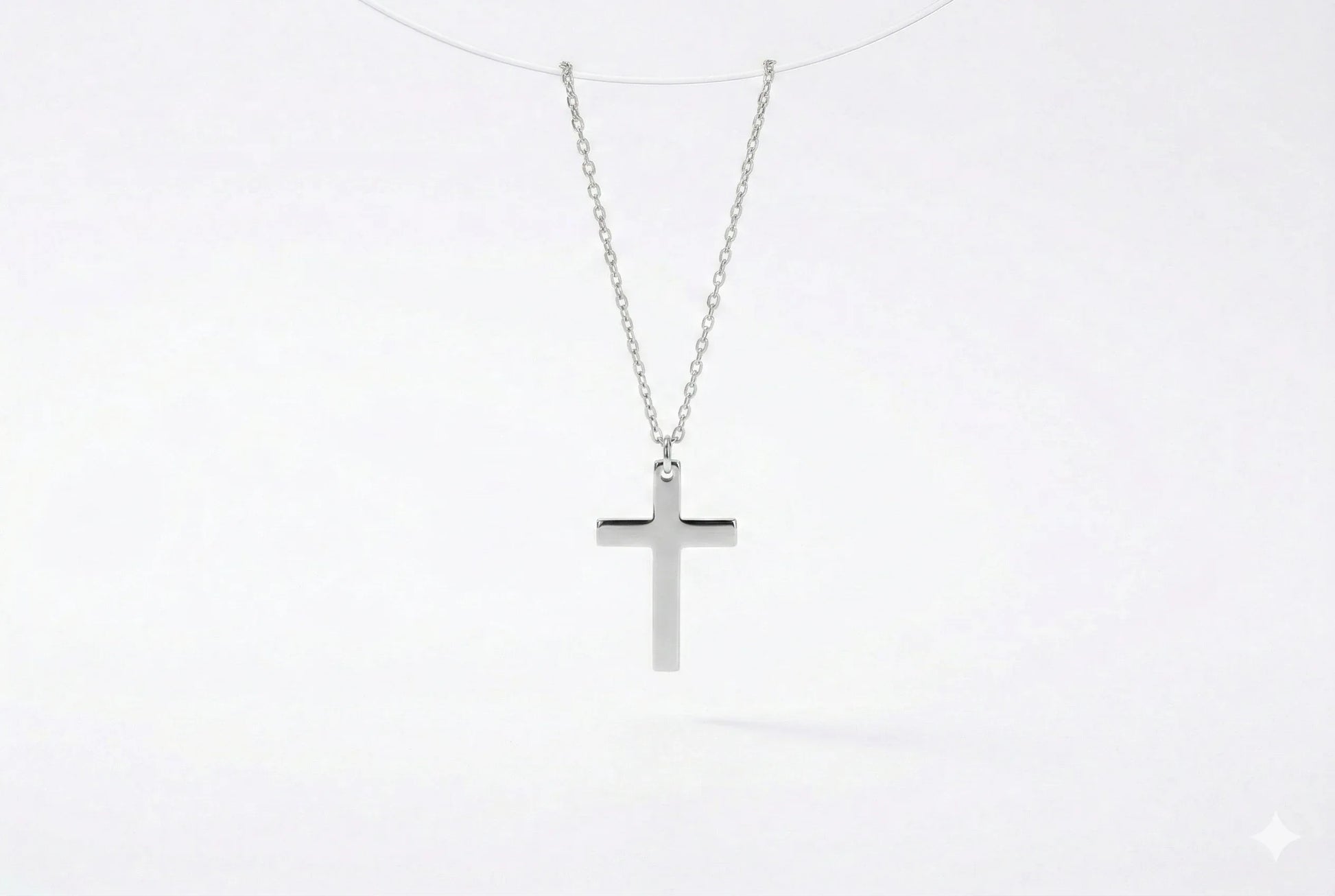 Silver cross necklace on a white background
