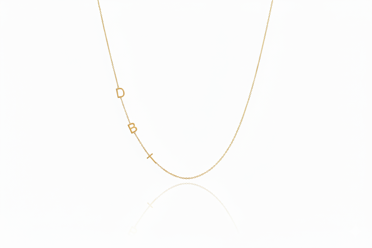 Gold necklace with small geometric pendants on a white background