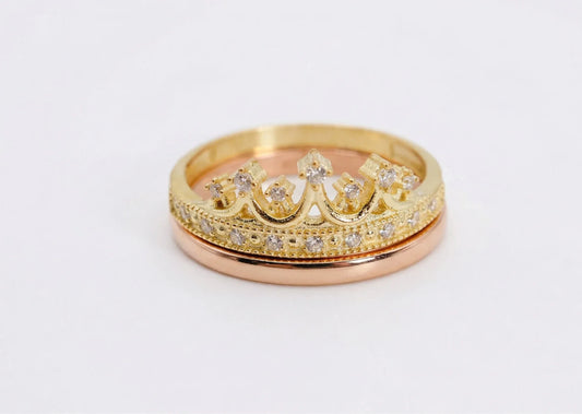 Two gold rings with diamond accents on a white background