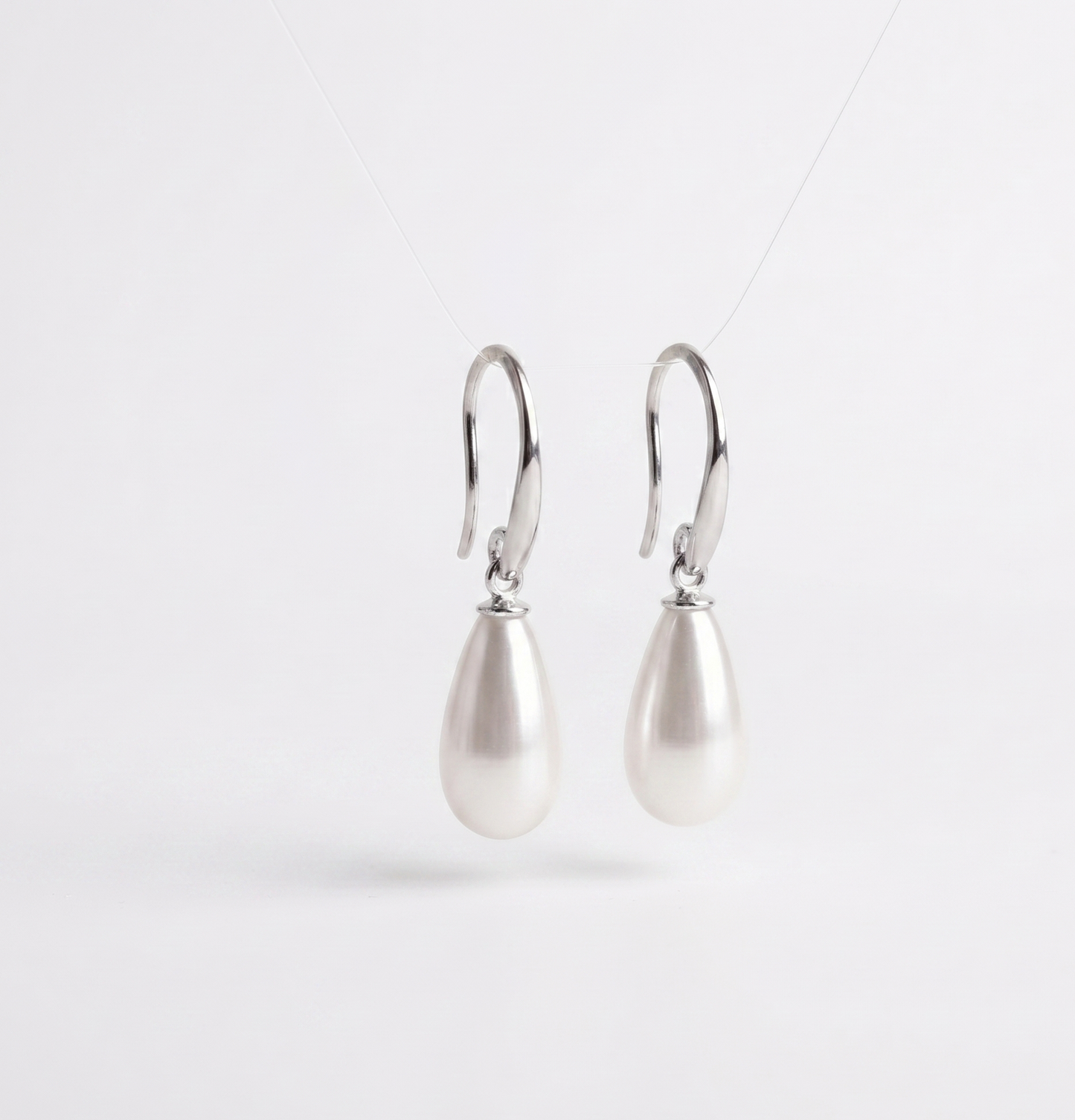 Pair of pearl earrings on a white background