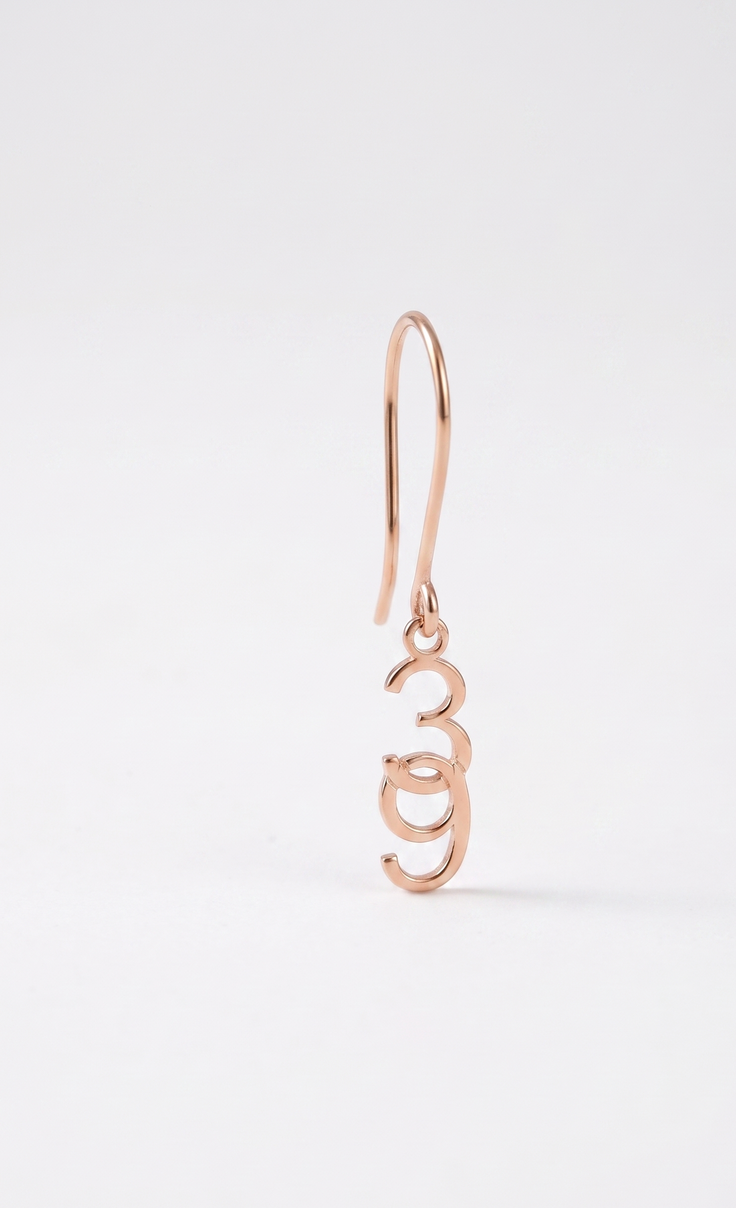Rose gold earring on a white background