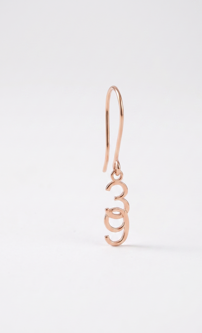 Rose gold earring on a white background