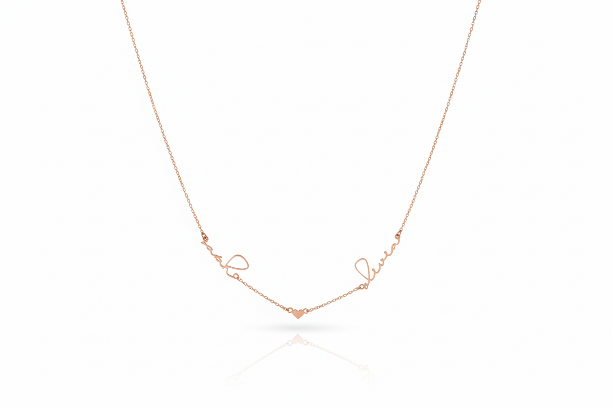 Rose gold necklace with 'love' engraving on a white background