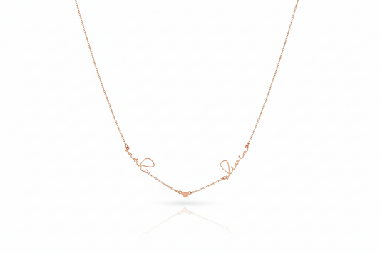 Rose gold necklace with 'love' engraving on a white background