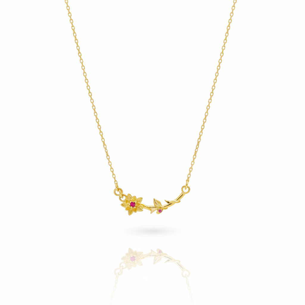 Gold necklace with floral pendant on a white background