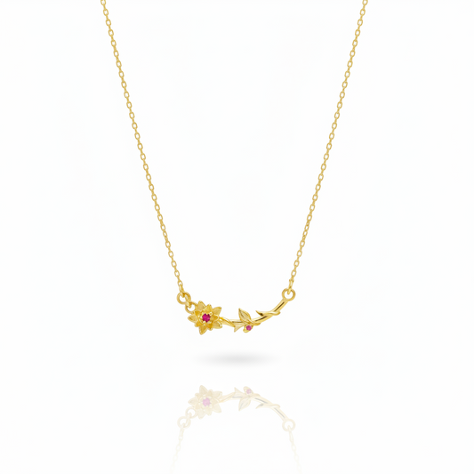 Gold necklace with floral pendant on a white background