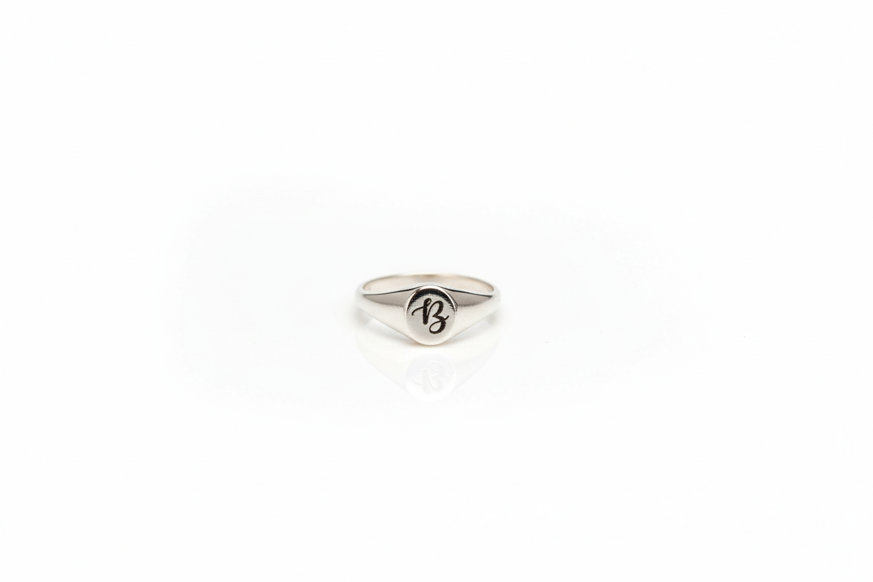 Silver ring with a logo on a white background