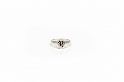 Silver ring with a logo on a white background