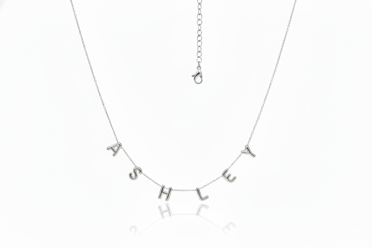 Silver necklace with 'ASHLEY' on a white background