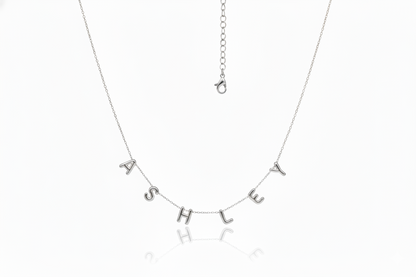 Silver necklace with 'ASHLEY' on a white background