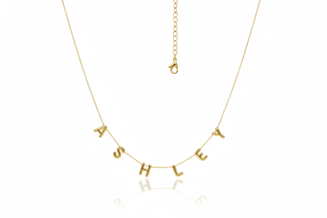 Gold necklace with 'ASHLEY' letters on a white background
