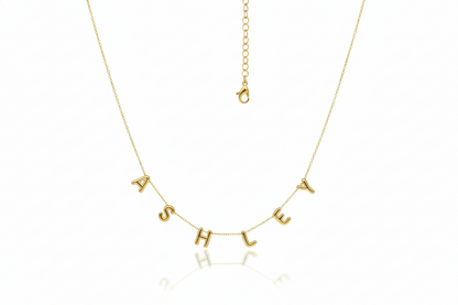 Gold necklace with 'ASHLEY' letters on a white background