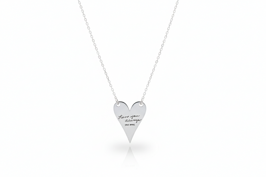 Heart-shaped silver necklace with engraved text on a white background