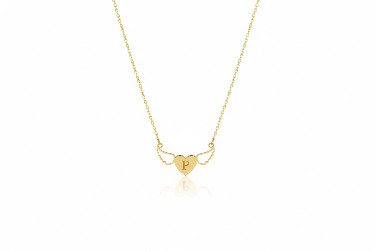 Gold necklace with a heart-shaped pendant on a white background