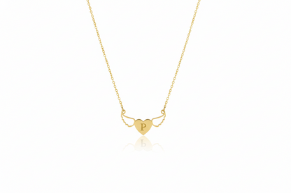 Gold necklace with a heart-shaped pendant on a white background
