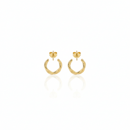 Gold hoop earrings on a white background