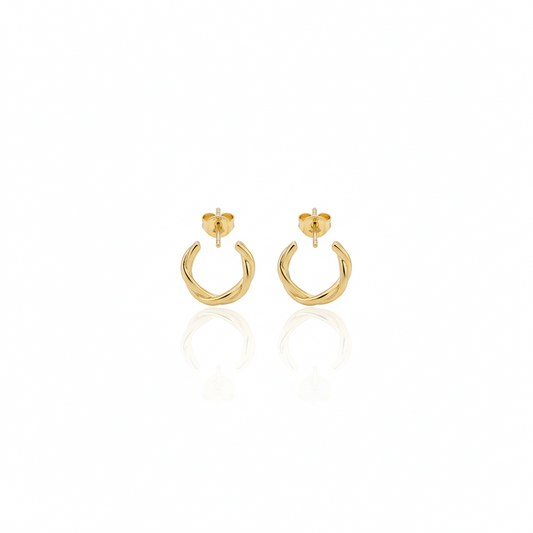 Gold hoop earrings on a white background