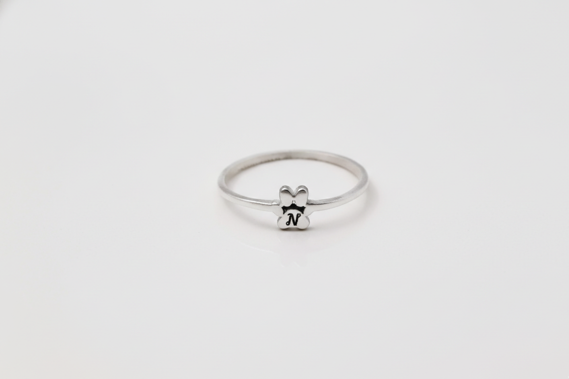 Silver ring with a small bear design on a white background