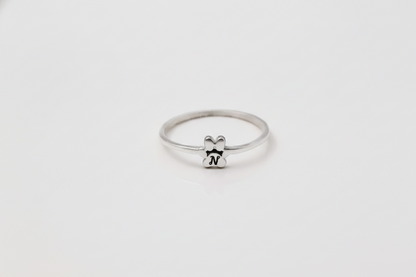 Silver ring with a small bear design on a white background