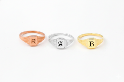 Three rings with initials 'R', 'A', and 'B' on a white background