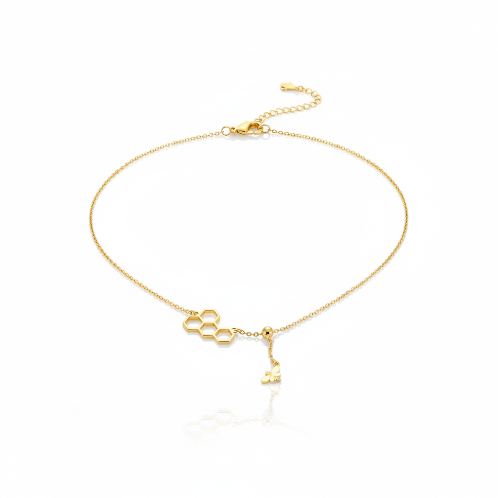 Gold bracelet with key charm on a white background