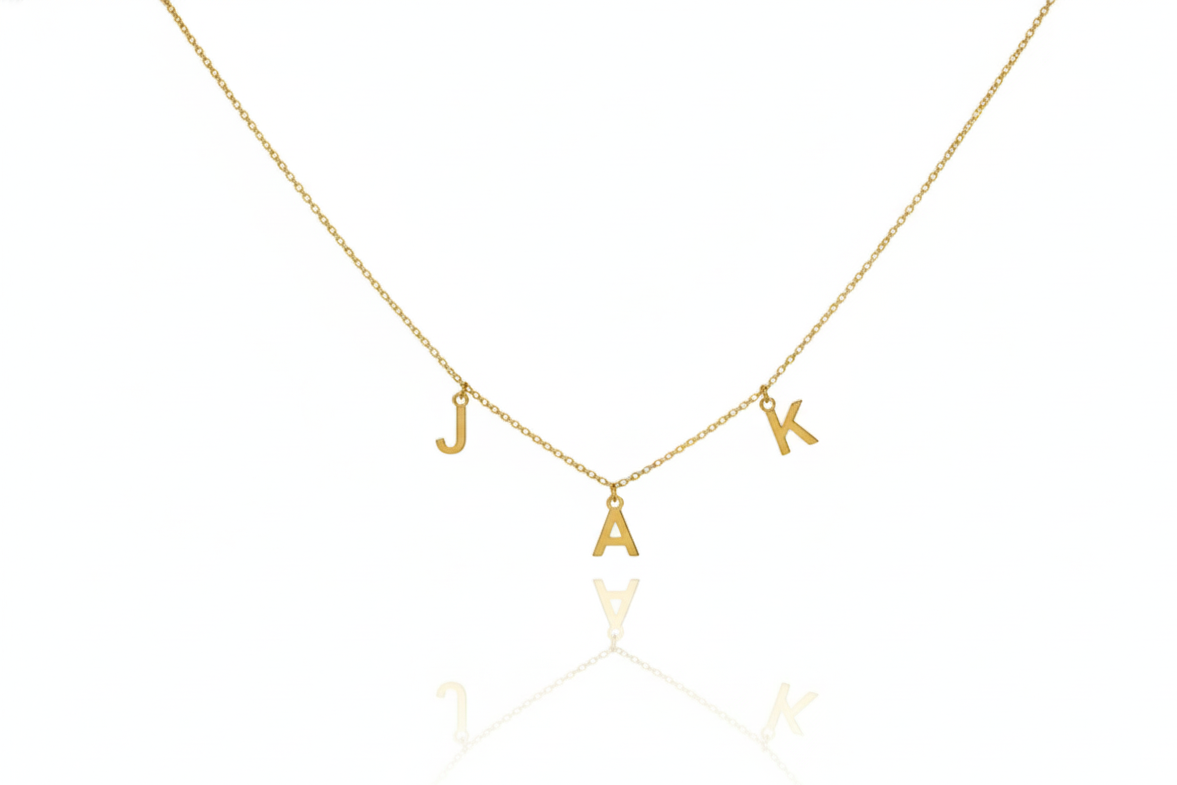 Gold necklace with 'JACK' letters on a white background