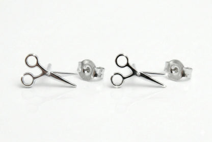 Scissor-shaped stud earrings on a white background