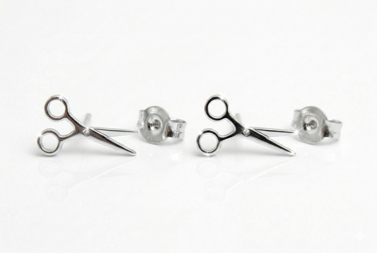 Scissor-shaped stud earrings on a white background