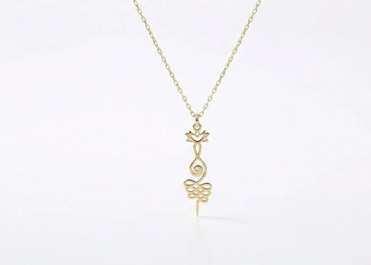 Gold necklace with a delicate pendant on a white background