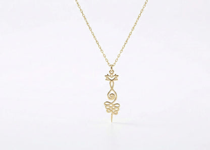 Gold necklace with a delicate pendant on a white background