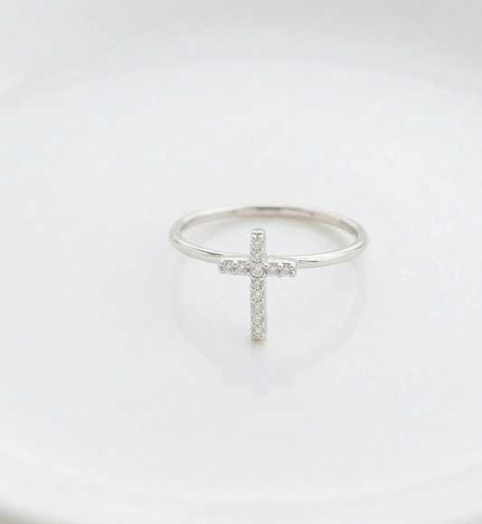 Silver ring with a cross design on a white background