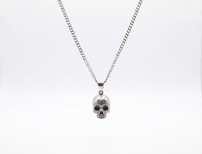 Silver skull pendant necklace on a white background