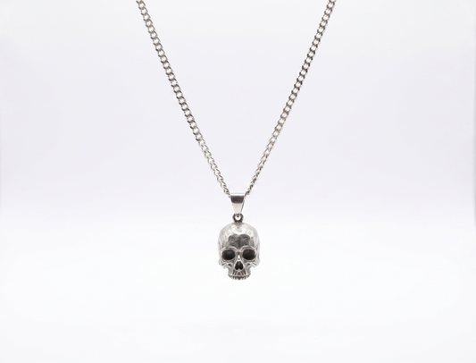 Silver skull pendant necklace on a white background