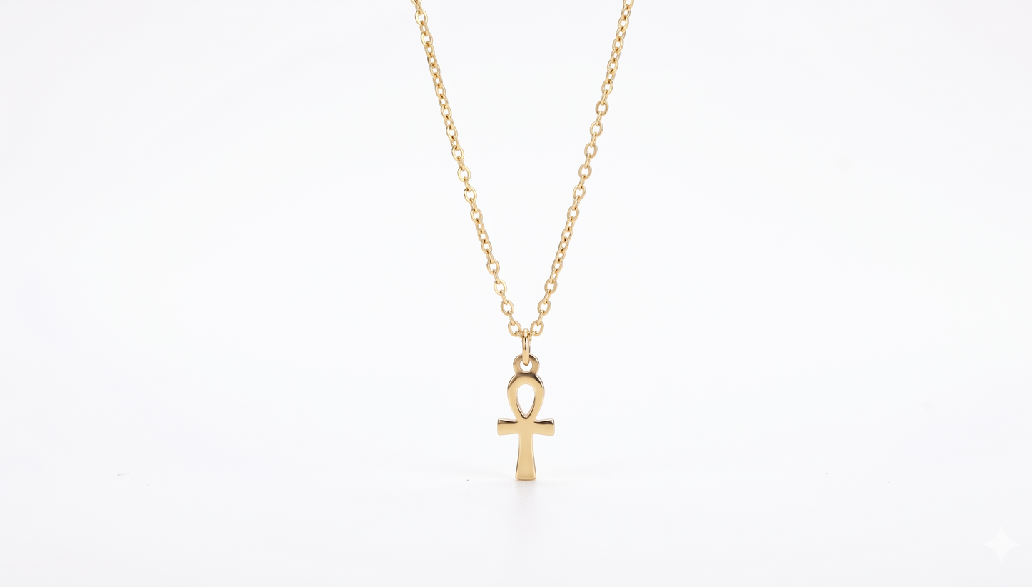 Gold necklace with an ankh pendant on a white background