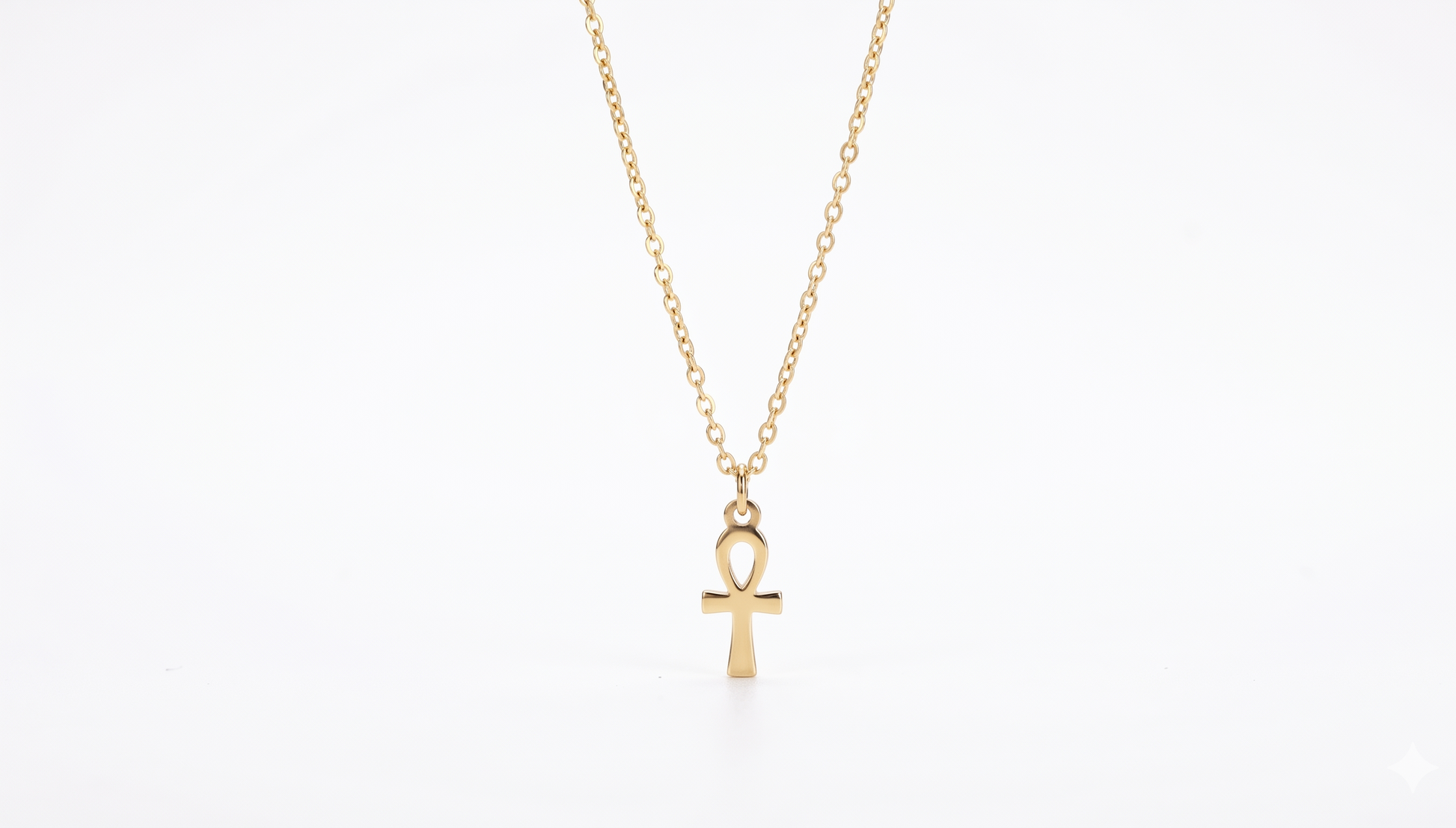 Gold necklace with an ankh pendant on a white background