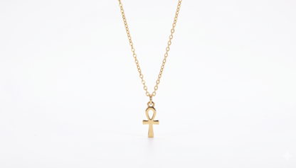 Gold necklace with an ankh pendant on a white background