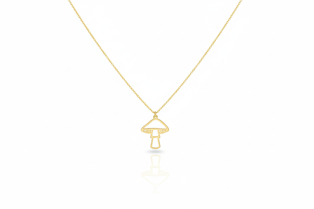 Gold necklace with a mushroom pendant on a white background